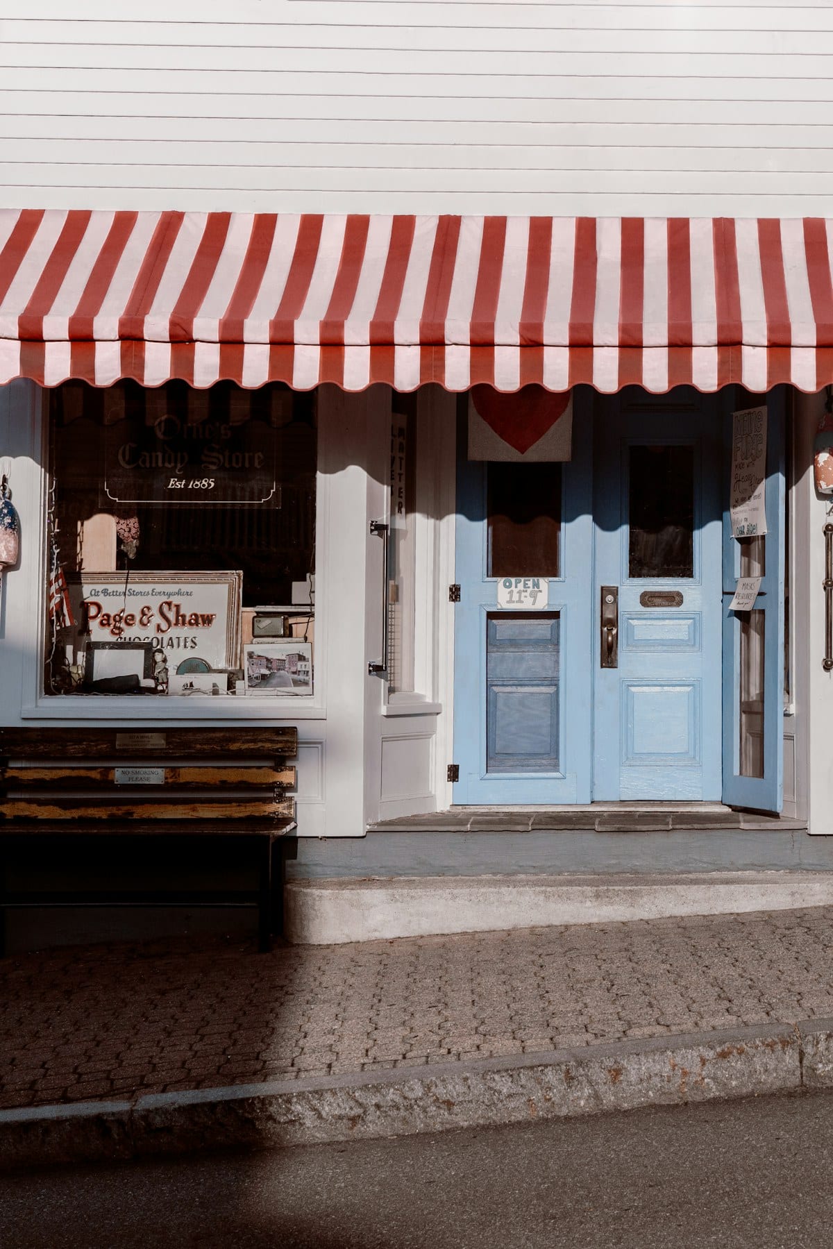 Storefront with a striped awning, representing the local shopping districts near Hurst, TX